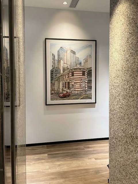 Framed city-street artwork on a hallway wall.