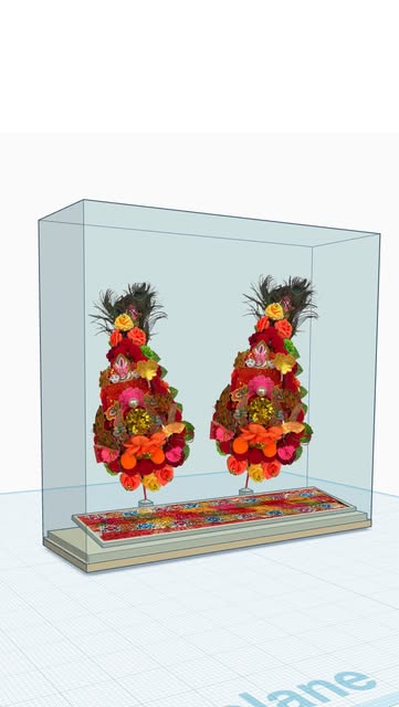 Two colorful floral ornaments in a clear display-case design.
